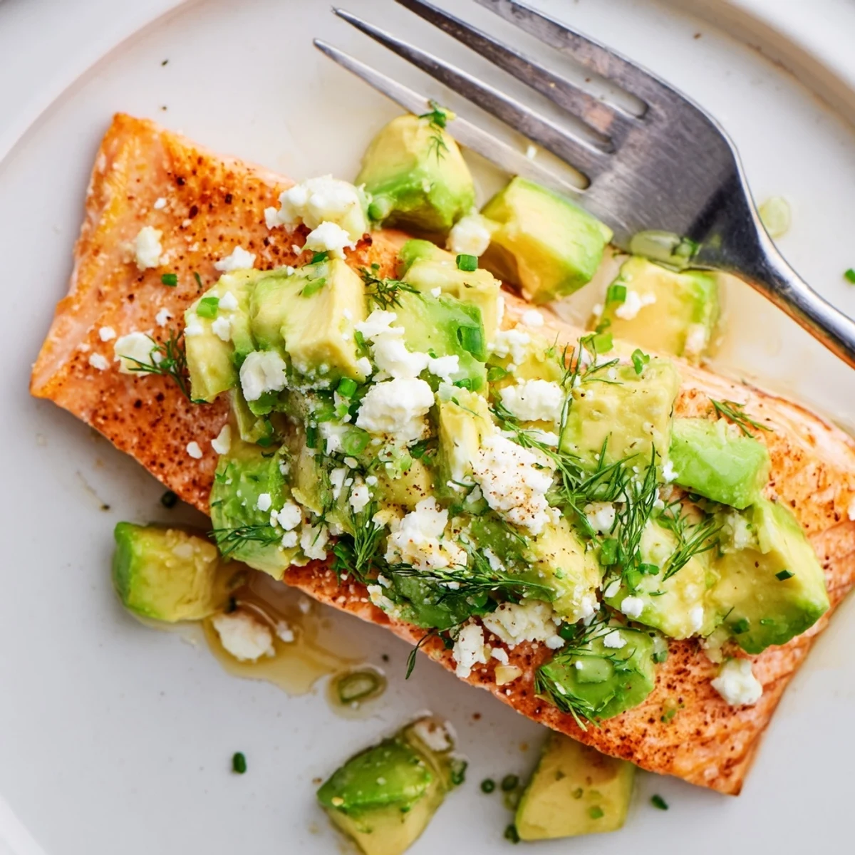 Delicious baked salmon with creamy avocado and feta cheese topping, ready in under 30 minutes.  