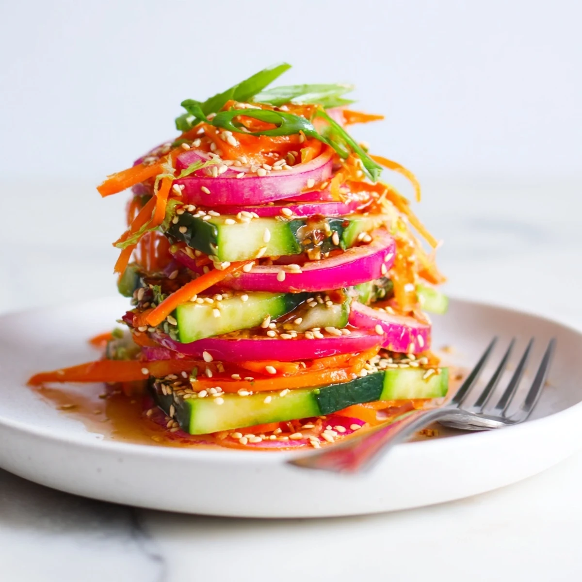 Refreshing cucumber salad remix tossed with ginger, garlic, and colorful veggies.  