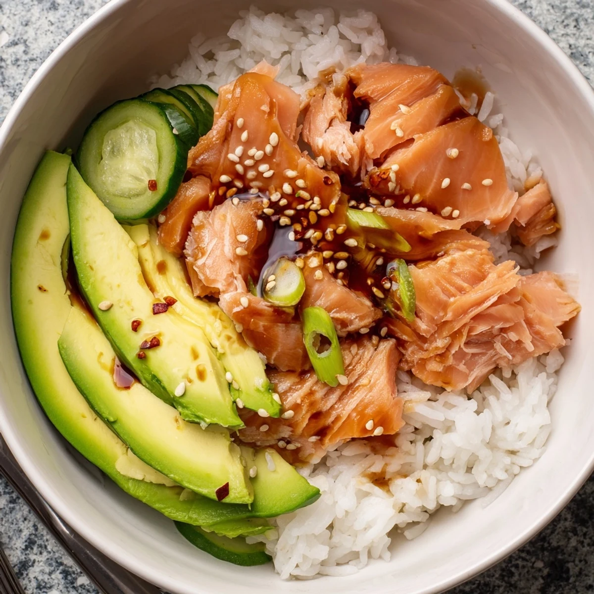 Flavorful leftover salmon and rice bowl, topped with pickled ginger and sesame seeds.  