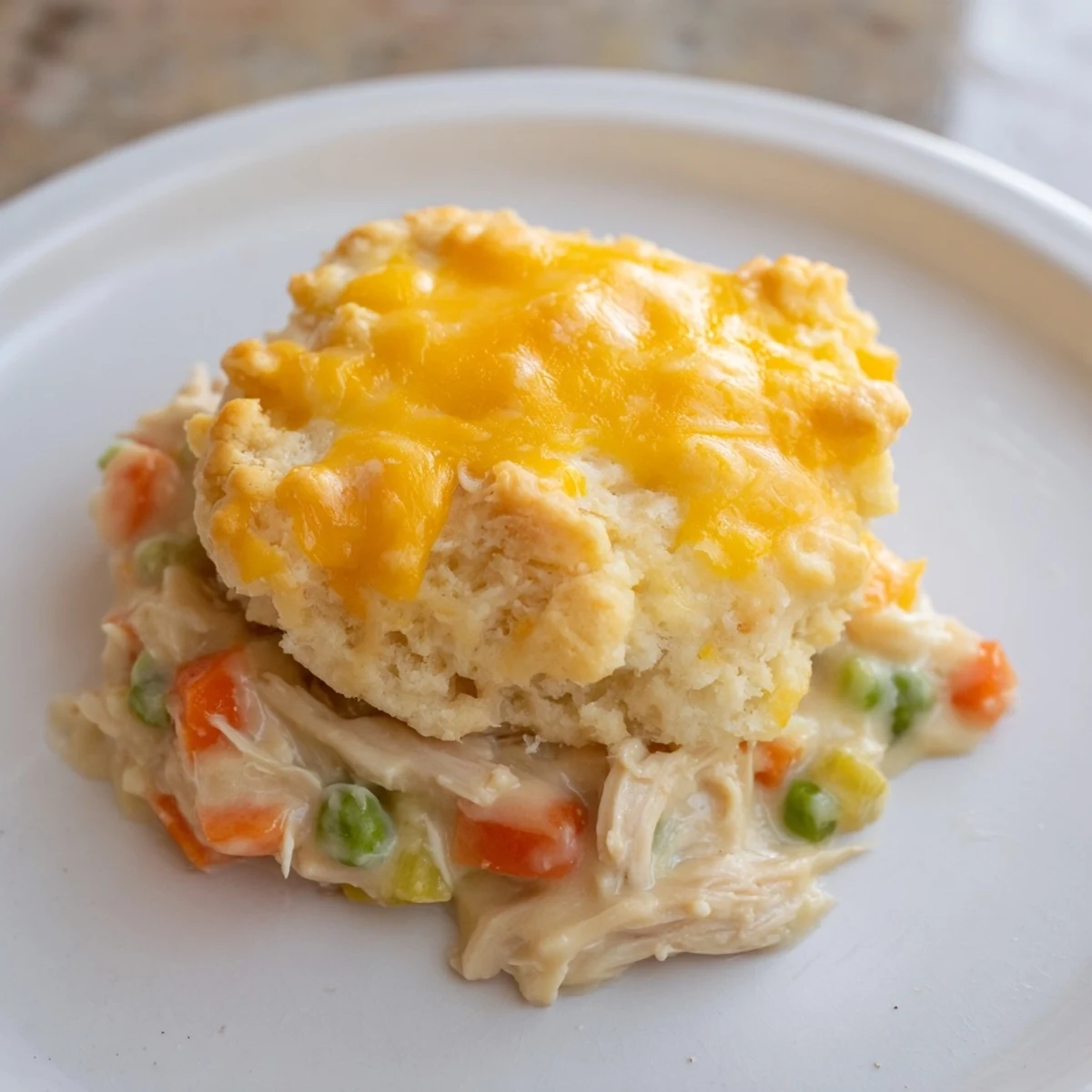 Golden, bubbly One-Pan Chicken Cobbler with cheesy biscuits and tender chicken in a creamy sauce.
