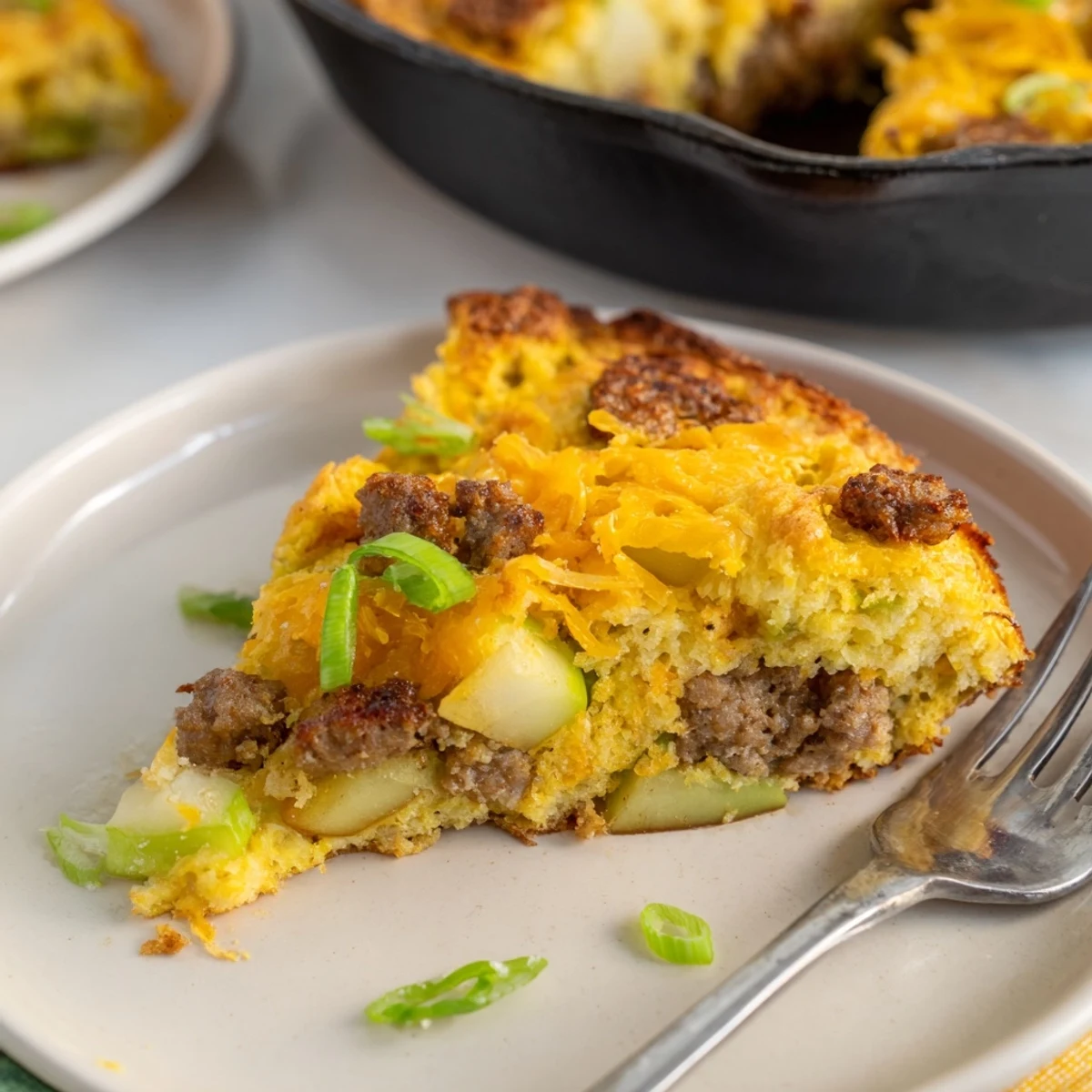 Warm, golden-brown Savory Apple, Sausage, and Cheddar Scone Skillet, perfect for a cozy brunch.