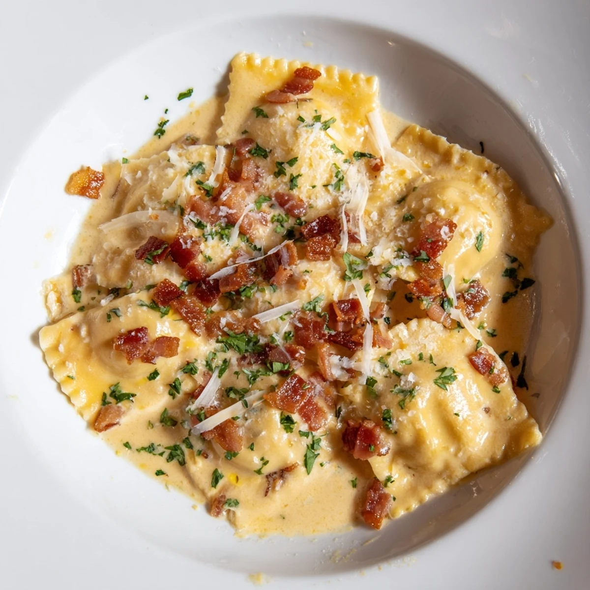 A close-up of delicious Olive Garden Ravioli Carbonara with crispy pancetta and fresh parsley garnish.