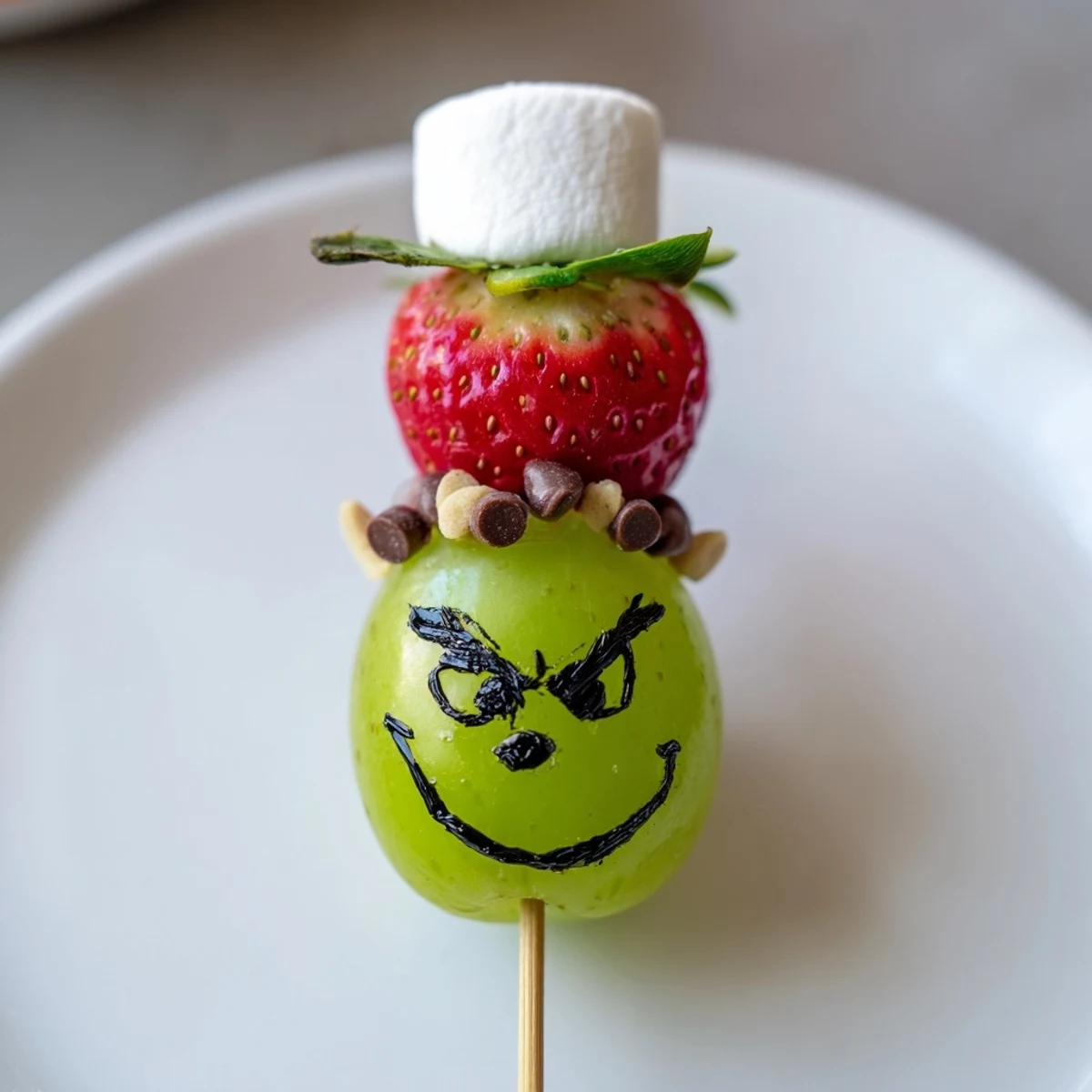 Get creative making this Grinch Snack! Grapes, marshmallows, and sprinkles complete this charming edible art!