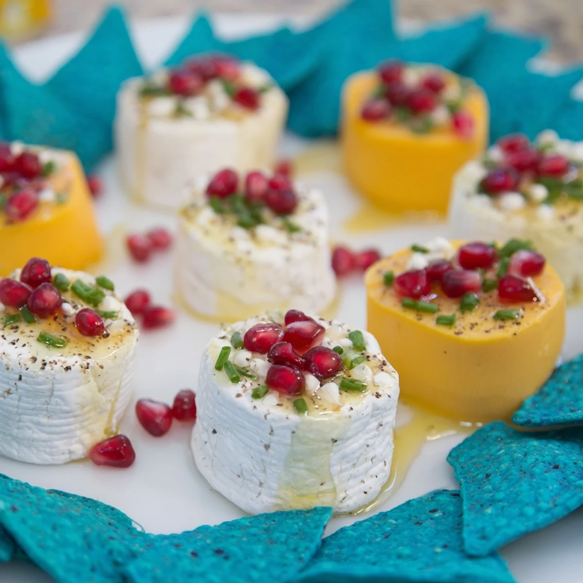 Appetizing "Stepping Stones" appetizer with cheese rounds on blue corn chip "river", garnished beautifully.