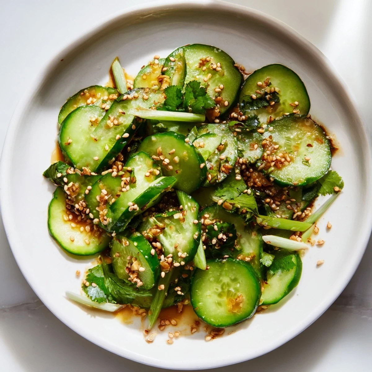 Vibrant Tangy Shaken Asian-Style Cucumber Salad with glistening cucumbers tossed in the bright dressing.