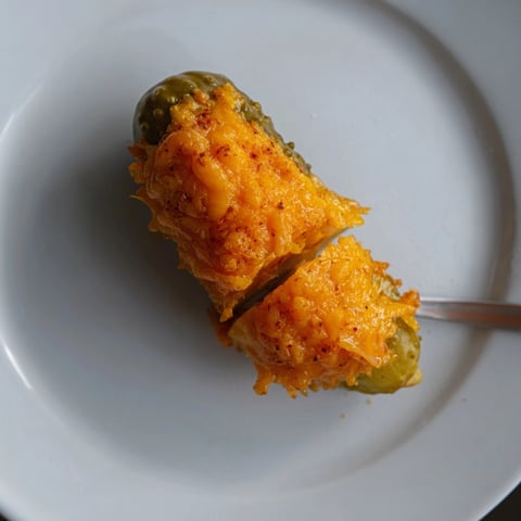 Crispy cheddar cheese melting around a tangy dill pickle spear: Cheese-Wrapped Pickles recipe.
