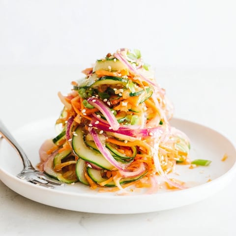 Vibrant cucumber salad remix with sesame dressing, perfect for a light appetizer.  