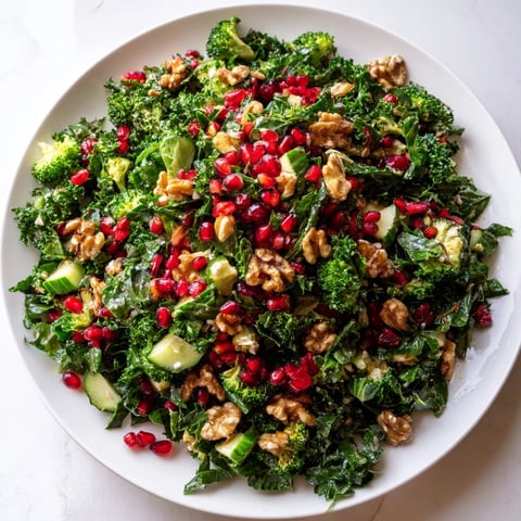 Vibrant Christmas Tree Salad with ruby pomegranate, creamy feta, and crunchy pecans, beautifully arranged.