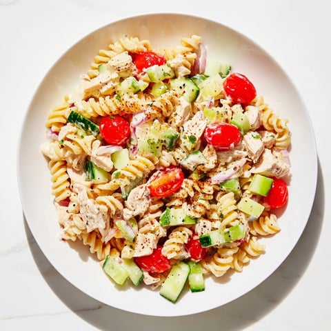 Everything Bagel Chicken Pasta Salad: A creamy cold pasta salad, bursting with fresh flavors, perfectly garnished.