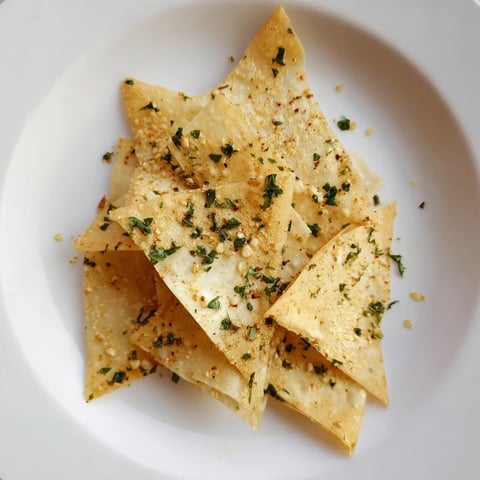 Golden-brown and crispy garlic lumpia chips ready to serve as a delicious, savory snack.