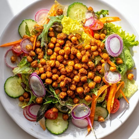 A fresh Mixed Greens Salad with crispy chickpea croutons, perfectly vibrant for a vegan meal.