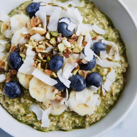 Creamy Matcha Overnight Oats topped with fresh berries, ready for a delicious breakfast.