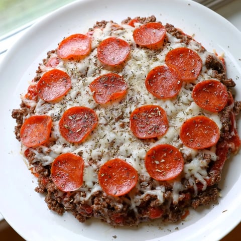 Meat Pizza Pepperoni Stack, a low-carb delight, features bubbly mozzarella and spicy pepperoni on a beef base.