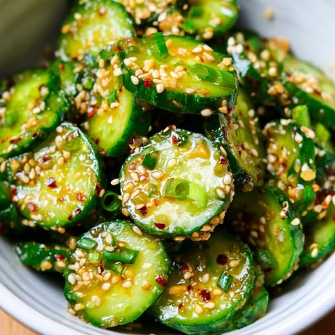 Fresh, crisp slices of Shake Shake Garlic Cucumbers glistening with soy-sesame dressing and a sprinkle of sesame seeds.