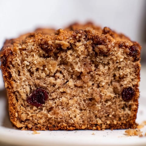 Warm, fragrant Cinnamon Applesauce Flax Loaf ready to slice; nuts and spices visible.