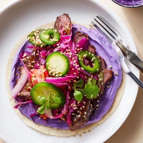 Flavorful Global Street-Food Fusion Bowl featuring marinated protein, rice, and colorful vegetables.  