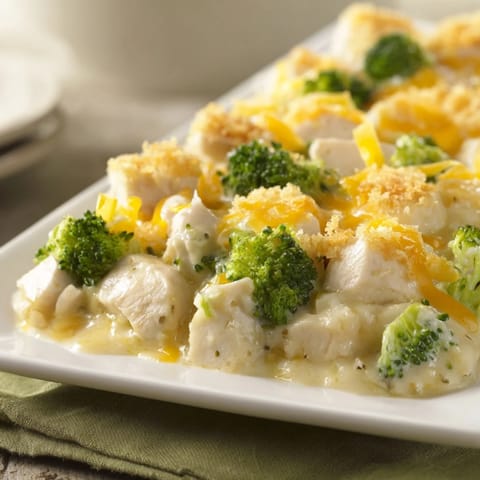 A close-up view of creamy Chicken & Broccoli Cheddar Bake filled with tender chicken and melted cheese.