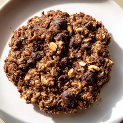 Warm, soft-looking chocolate oatmeal breakfast cookie, perfect for a quick and easy morning treat.
