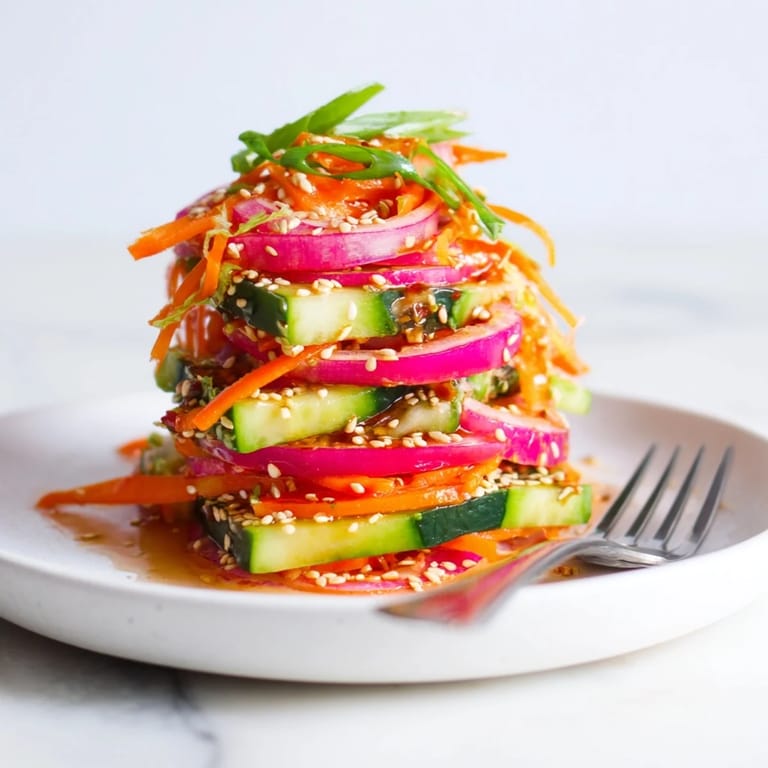 Refreshing cucumber salad remix tossed with ginger, garlic, and colorful veggies.  
