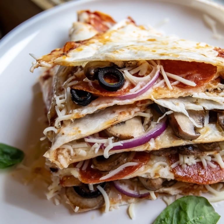 Crispy, layered Cheesy Tortilla Pizza Wrap filled with melted mozzarella, perfect for a quick snack.