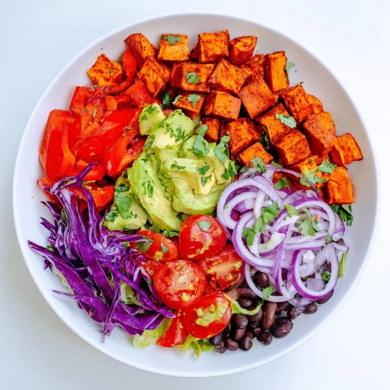 A colorful Sweet Potato Taco Bowl featuring roasted sweet potatoes and a medley of fresh toppings.