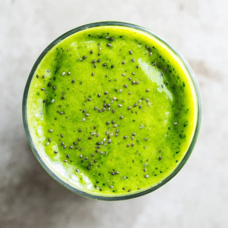 A refreshing Green Detox Smoothie beside sliced apples and bananas, perfect for a healthy, revitalizing start.